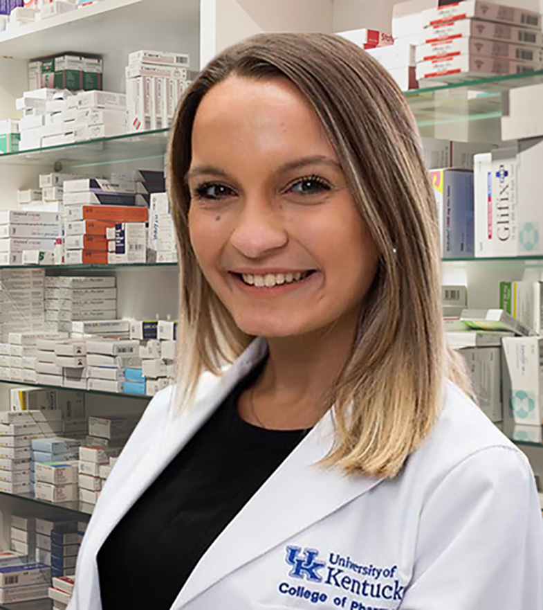 Girl in white coat standing in a pharmacy