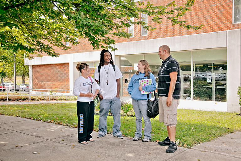 students on campus talking outside