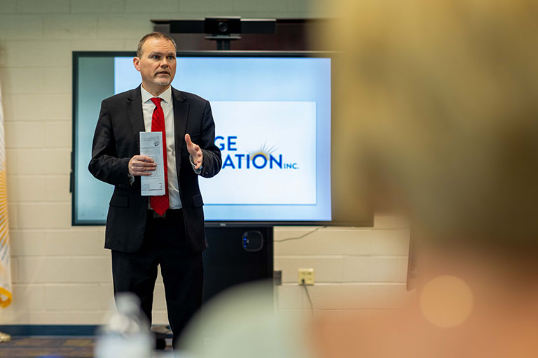 Dr. Warren talking at a meeting